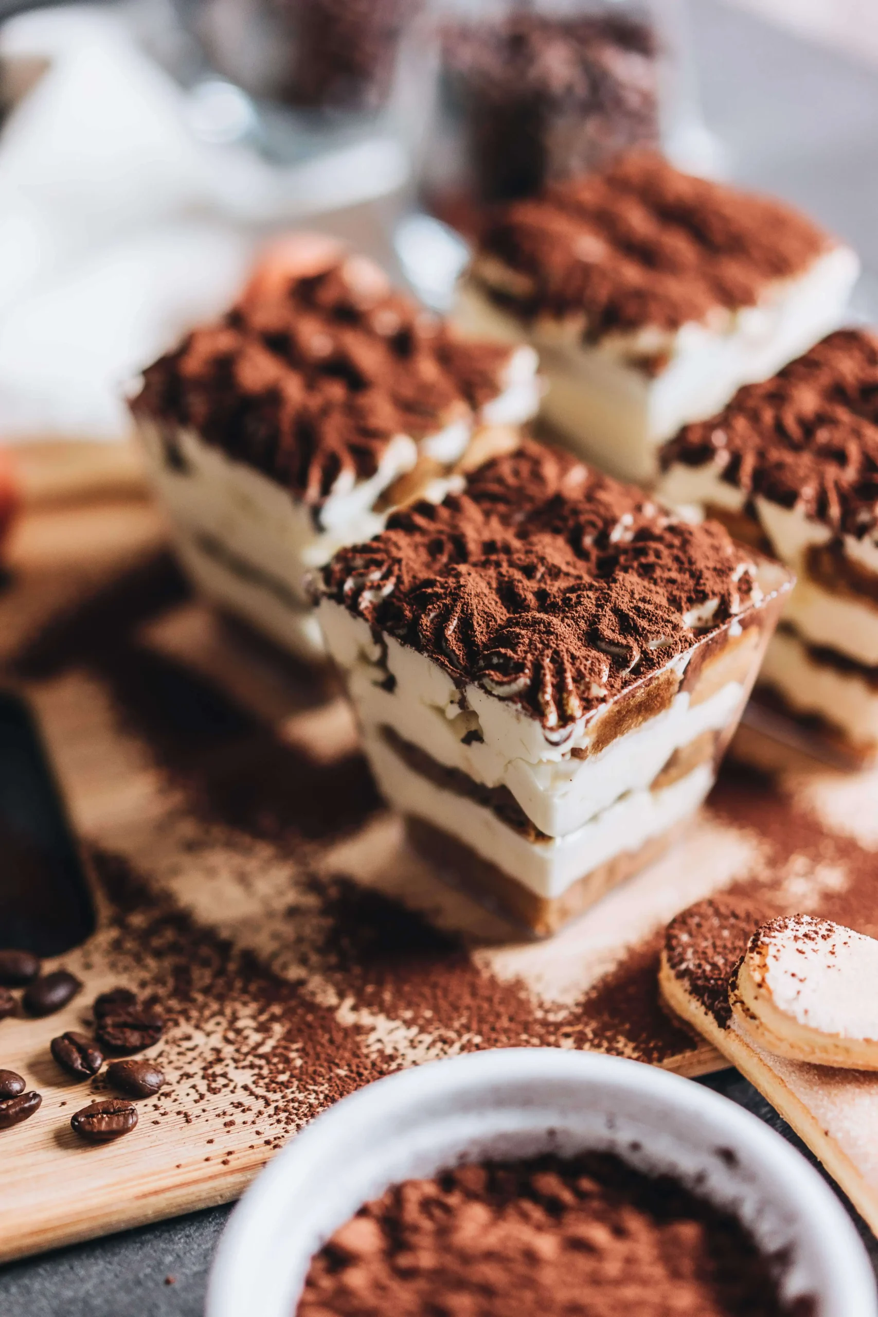 A close-up view of a decadent chocolate cake with a smooth, glossy ganache topping and a sprinkle of powdered sugar